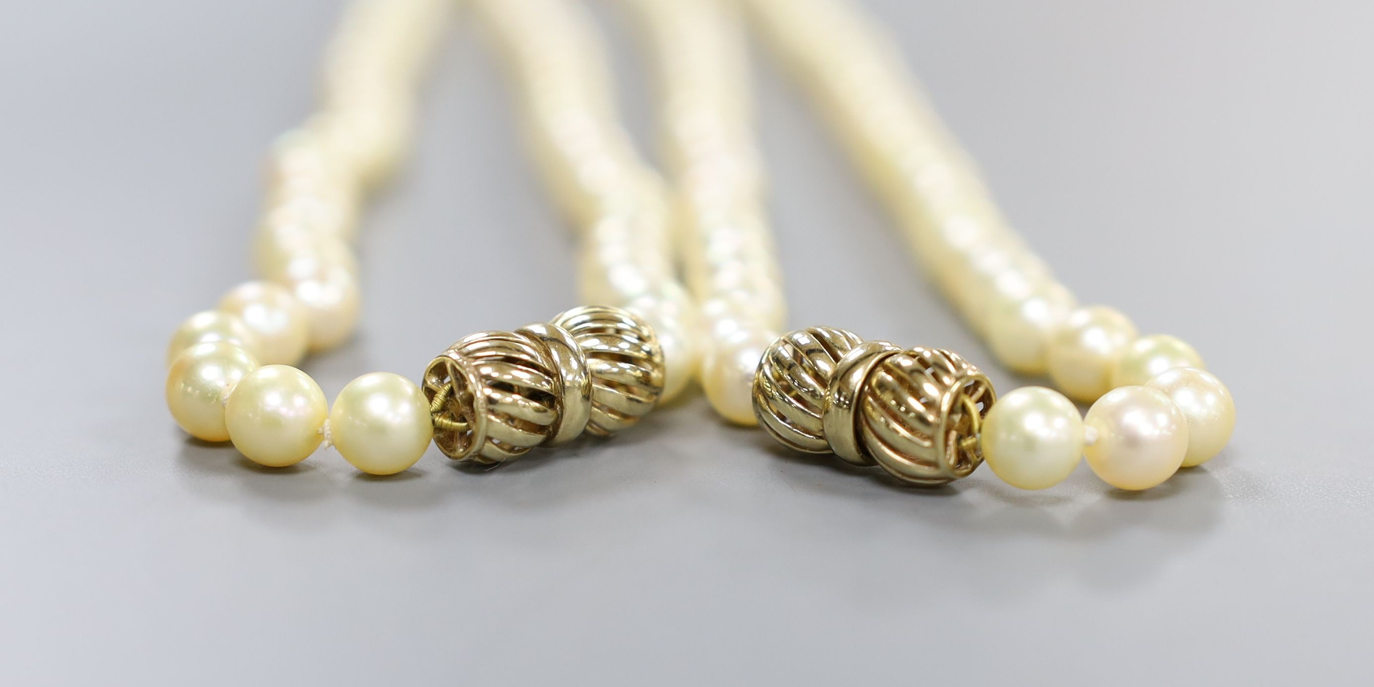 Two single strand cultured pearl necklaces, with 9ct clasps, (can be worn as one), overall 88cm.
